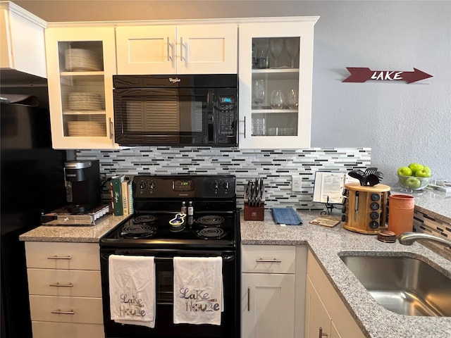 kitchen featuring white cabinetry, tasteful backsplash, black appliances, sink, and light stone countertops