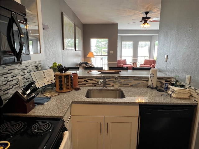 kitchen featuring white cabinetry, black appliances, sink, ceiling fan, and light stone countertops