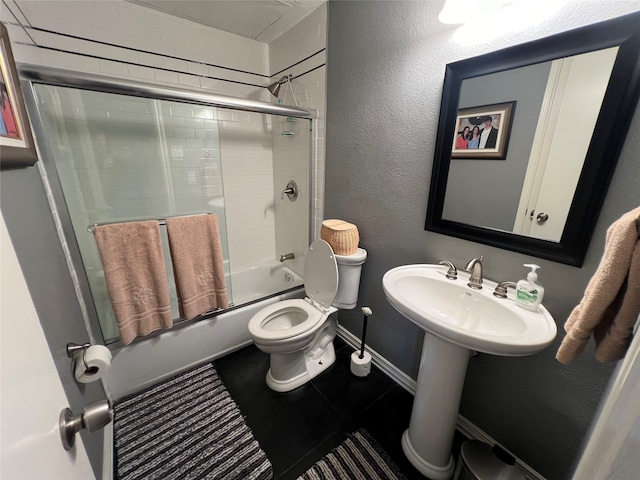 bathroom featuring enclosed tub / shower combo and toilet