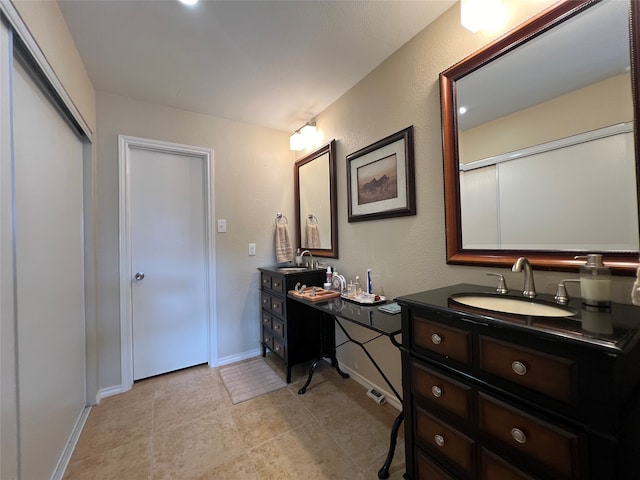 bathroom with tile patterned flooring and vanity