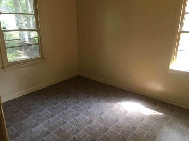 unfurnished room with tile patterned flooring