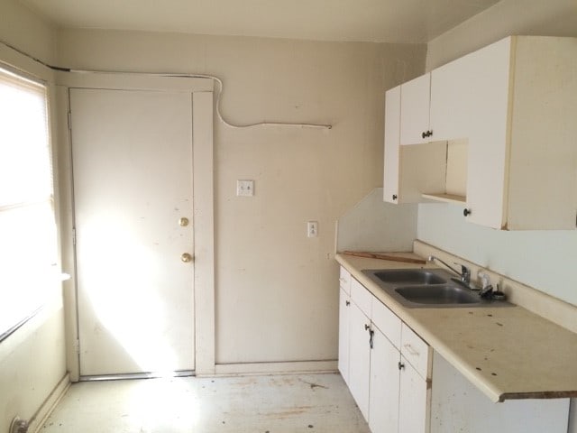 kitchen with sink and white cabinetry