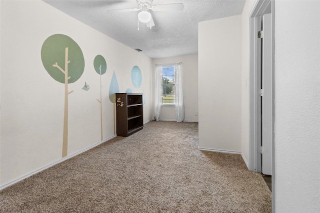 interior space with a textured ceiling and carpet flooring