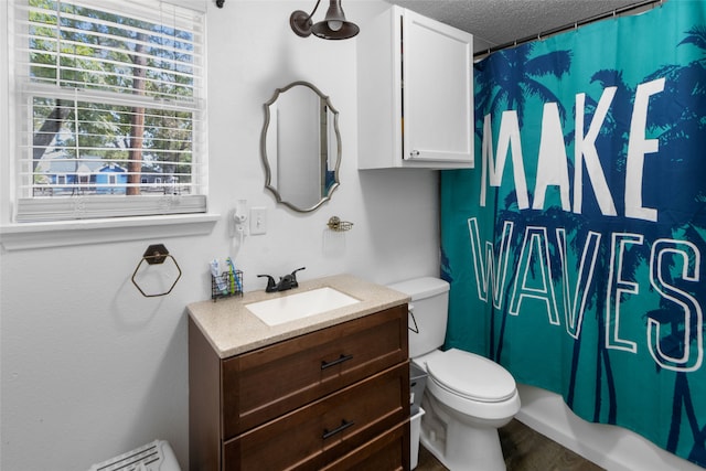 full bathroom with toilet, vanity, a textured ceiling, shower / bath combo, and hardwood / wood-style flooring