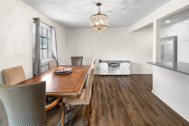 dining space with dark wood-type flooring, a chandelier, and a textured ceiling