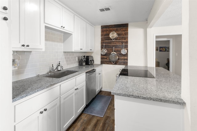 kitchen with tasteful backsplash, dishwasher, dark hardwood / wood-style flooring, sink, and white cabinets