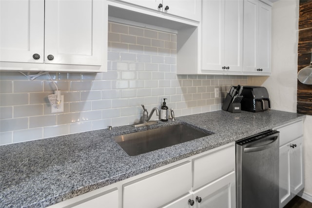 kitchen with light stone countertops, stainless steel dishwasher, sink, decorative backsplash, and white cabinets