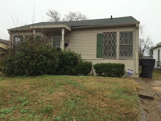 view of side of home with a lawn