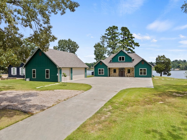 view of front facade featuring a garage, an outbuilding, and a front yard