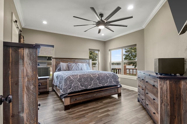 bedroom featuring ceiling fan, crown molding, and dark hardwood / wood-style flooring