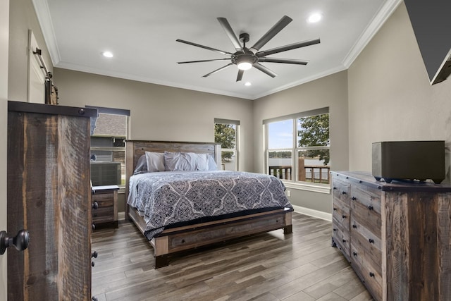 bedroom with recessed lighting, crown molding, baseboards, and wood finished floors