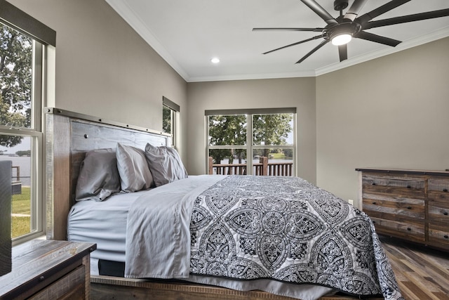 bedroom with ornamental molding, multiple windows, and wood finished floors