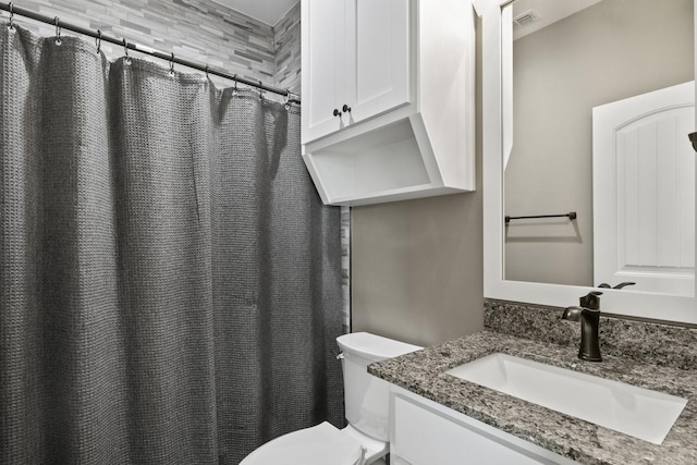 bathroom featuring visible vents, vanity, and toilet