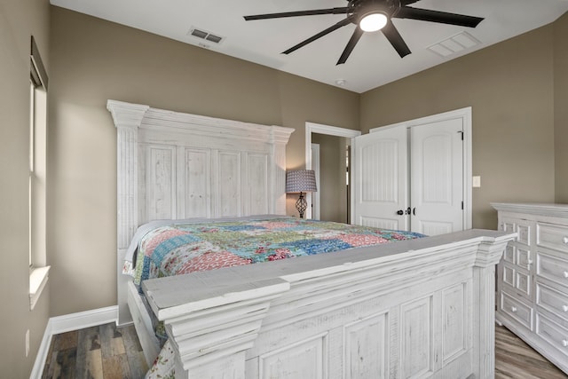 bedroom with ceiling fan, a closet, and wood-type flooring