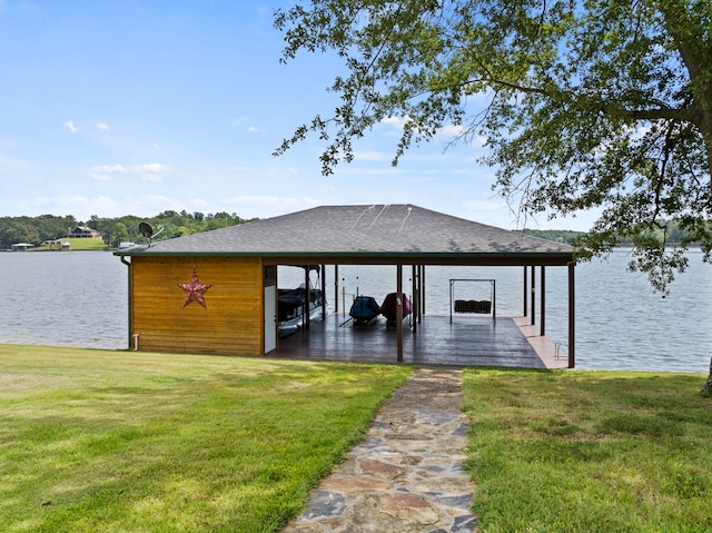 dock area with a yard and a water view