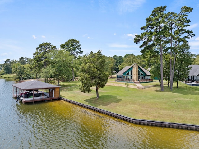 view of dock featuring a lawn and a water view