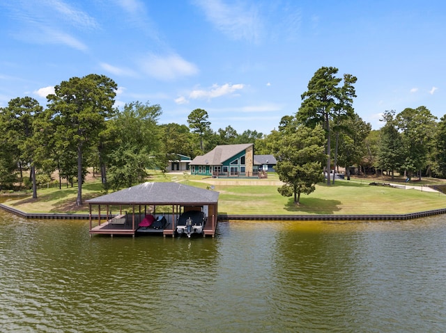 dock area with a lawn and a water view