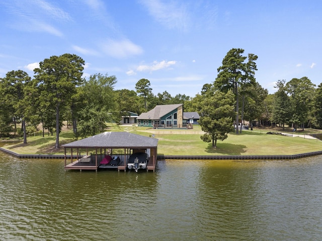 view of dock with a lawn and a water view