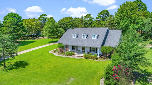 cape cod house with a front yard and covered porch