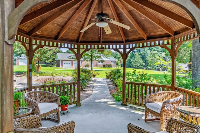 view of patio / terrace with a gazebo, ceiling fan, and an outdoor structure