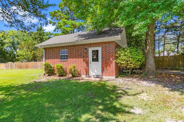 view of outbuilding with a yard