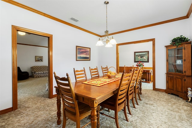 carpeted dining room featuring ornamental molding and an inviting chandelier