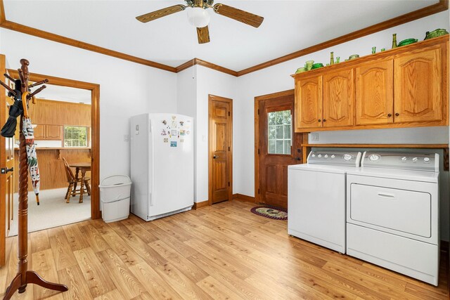 clothes washing area with ceiling fan, light hardwood / wood-style floors, cabinets, and washing machine and dryer