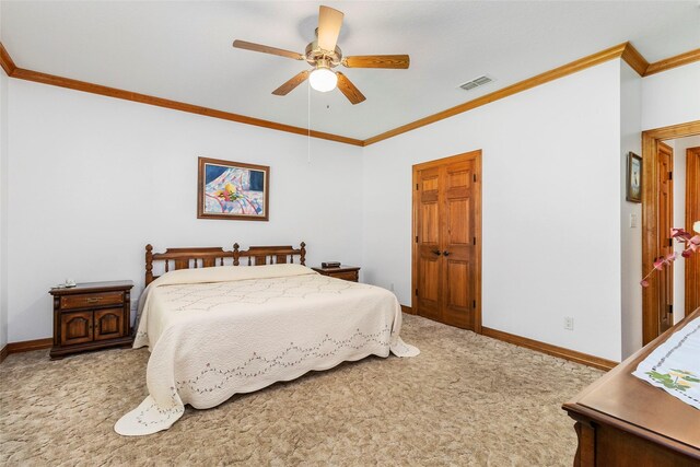 carpeted bedroom with ceiling fan, ornamental molding, and a closet