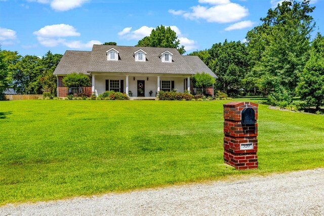 cape cod-style house featuring a front lawn