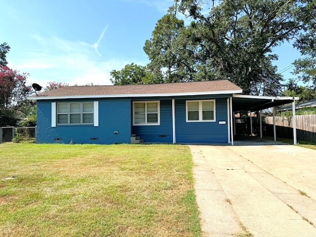 ranch-style home featuring a front lawn and a carport