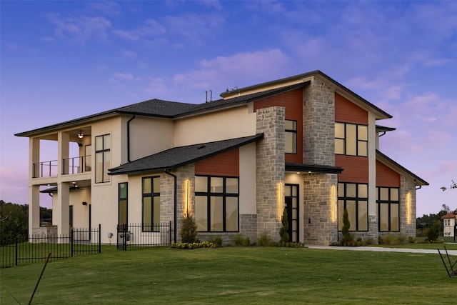 exterior space featuring a balcony and a lawn