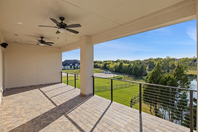 view of patio featuring ceiling fan and a balcony