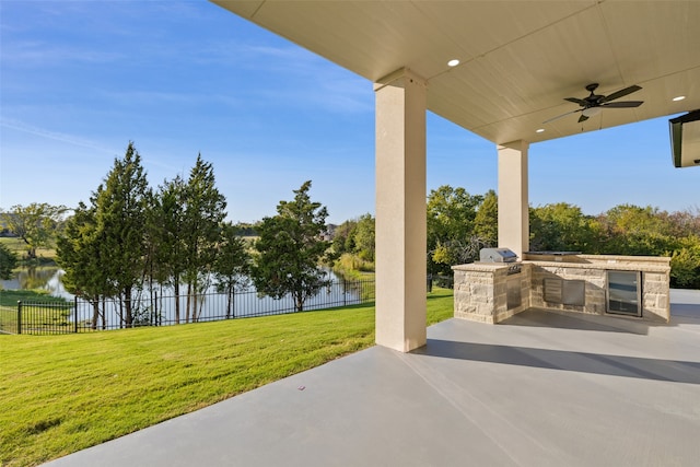 view of patio / terrace with ceiling fan, a water view, and area for grilling