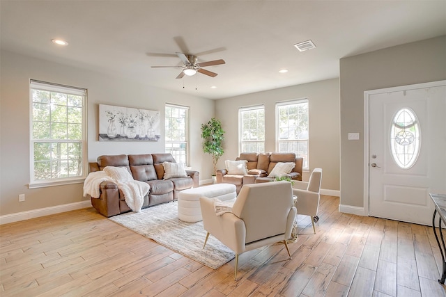 living room featuring light hardwood / wood-style flooring and ceiling fan