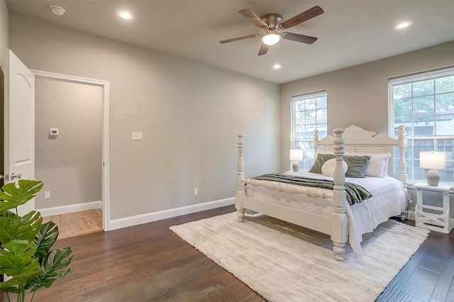 bedroom with dark hardwood / wood-style floors and ceiling fan