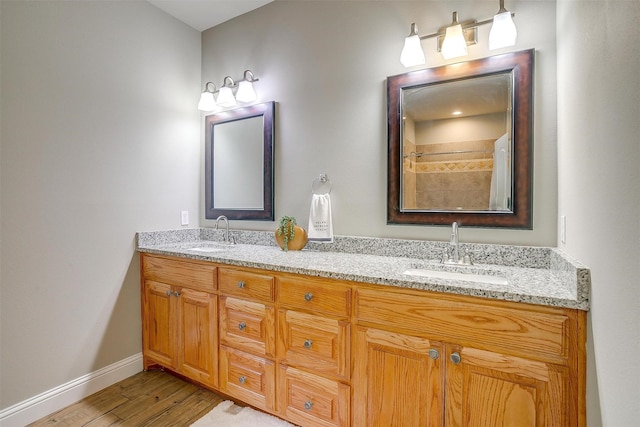 bathroom with wood-type flooring and vanity