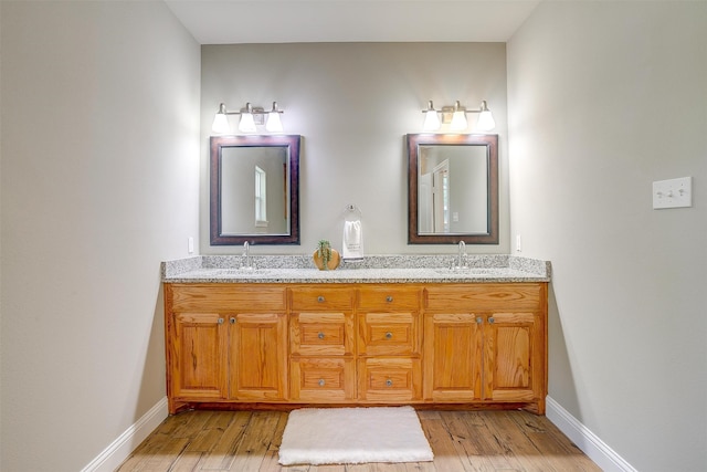 bathroom featuring hardwood / wood-style floors and vanity