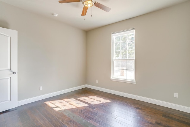 empty room featuring ceiling fan and dark hardwood / wood-style flooring