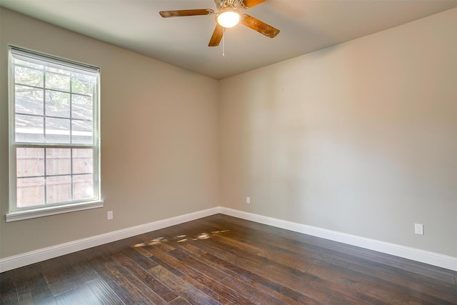 empty room with ceiling fan and dark hardwood / wood-style flooring