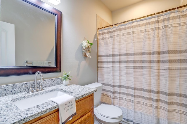 bathroom featuring a shower with curtain, vanity, and toilet