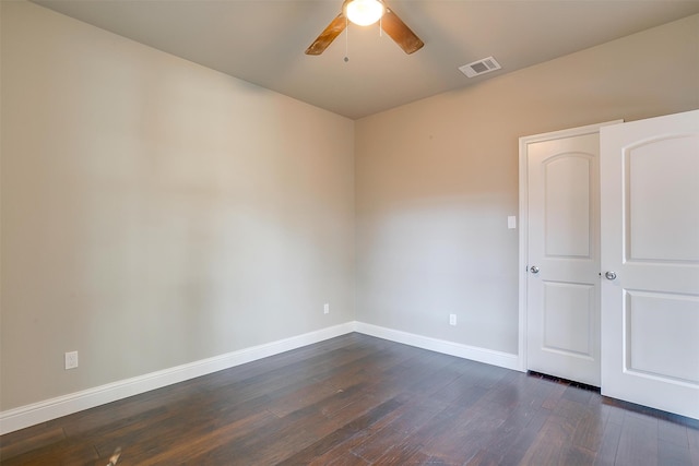 spare room featuring dark hardwood / wood-style floors and ceiling fan