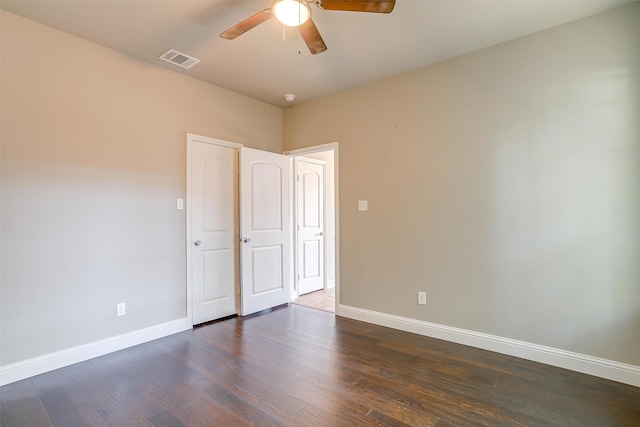 unfurnished bedroom with ceiling fan and dark wood-type flooring