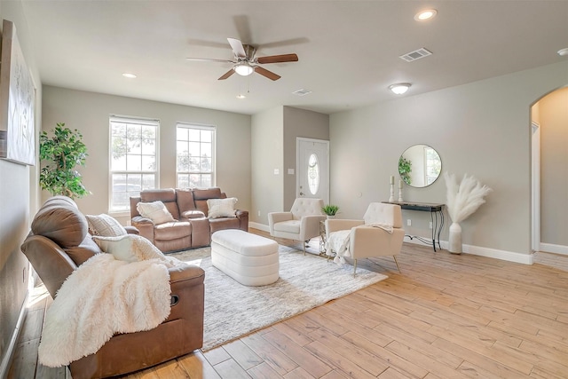 living room with ceiling fan and light wood-type flooring