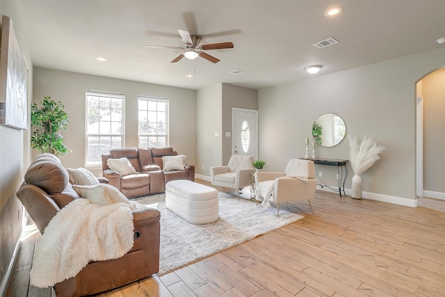 living room with light wood-type flooring and ceiling fan