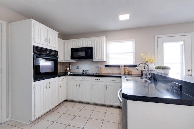 kitchen featuring sink, black appliances, white cabinetry, and light tile patterned floors