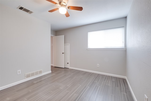 spare room with ceiling fan and light hardwood / wood-style flooring