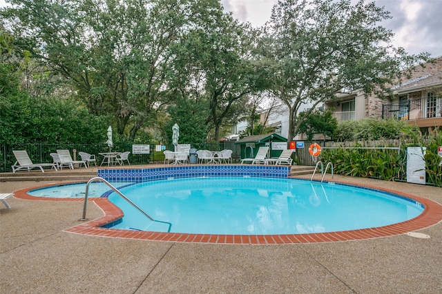 view of swimming pool with a patio