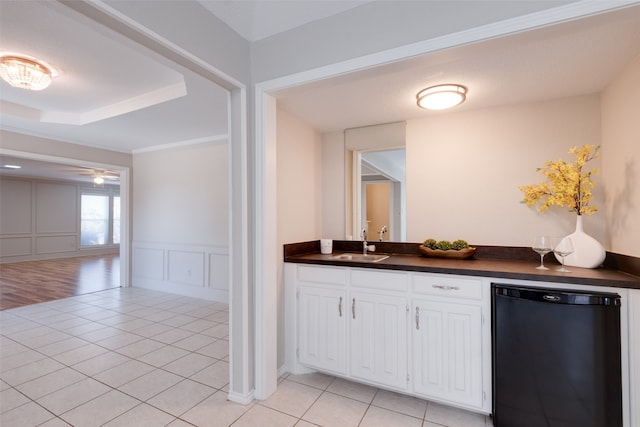 interior space with hardwood / wood-style floors, vanity, crown molding, a raised ceiling, and ceiling fan