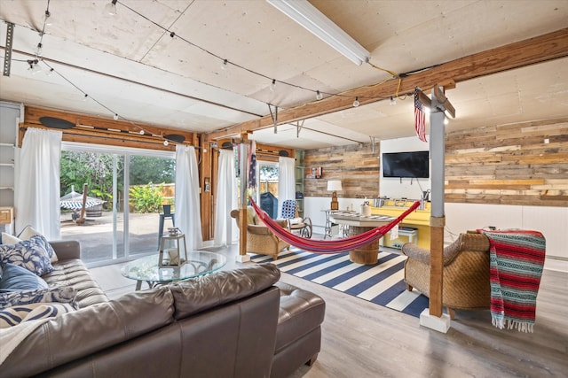 living room featuring wooden walls and hardwood / wood-style floors