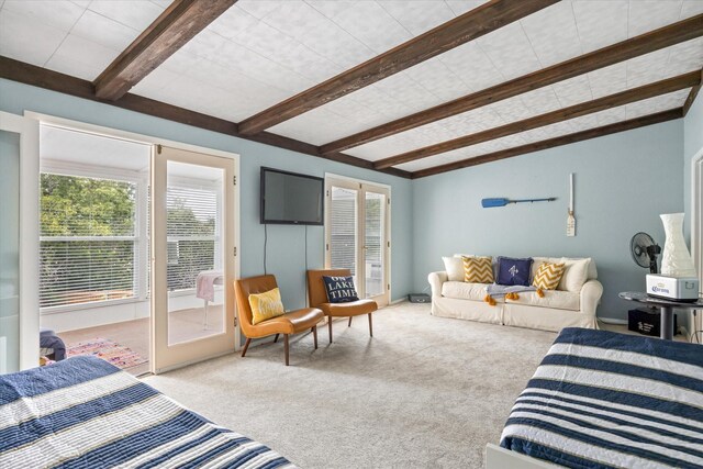 carpeted bedroom featuring beamed ceiling